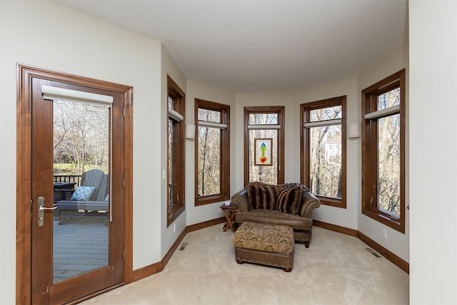 sitting room with a healthy amount of sunlight and light colored carpet