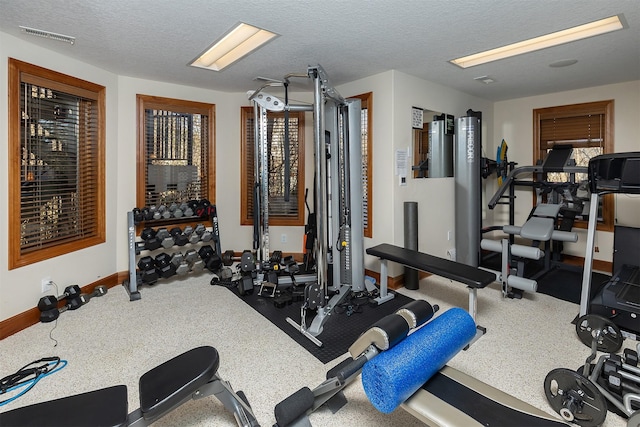 workout room with a textured ceiling