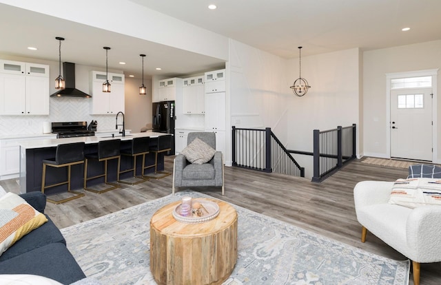 living room with hardwood / wood-style floors and sink