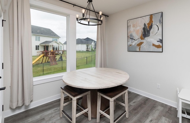 dining space featuring a notable chandelier and dark hardwood / wood-style floors