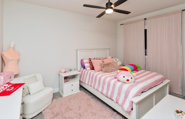 bedroom with ceiling fan and light carpet