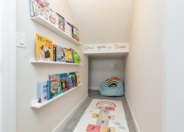 playroom with carpet floors and vaulted ceiling