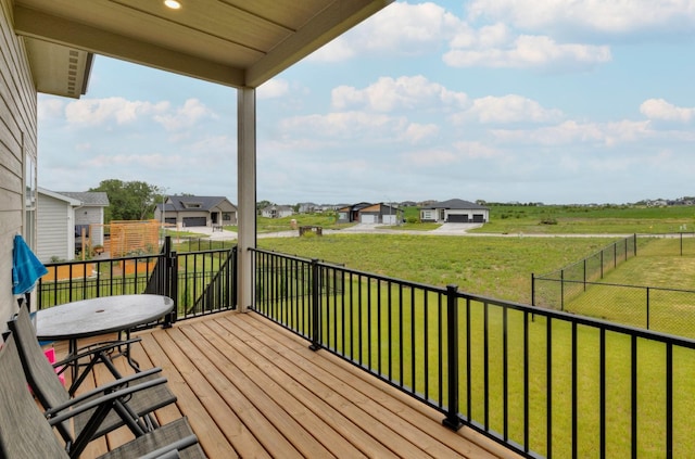 wooden terrace featuring a yard