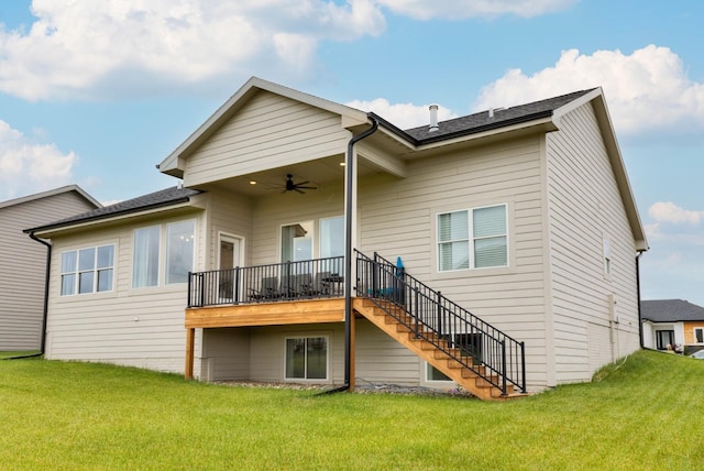 rear view of house with ceiling fan and a lawn