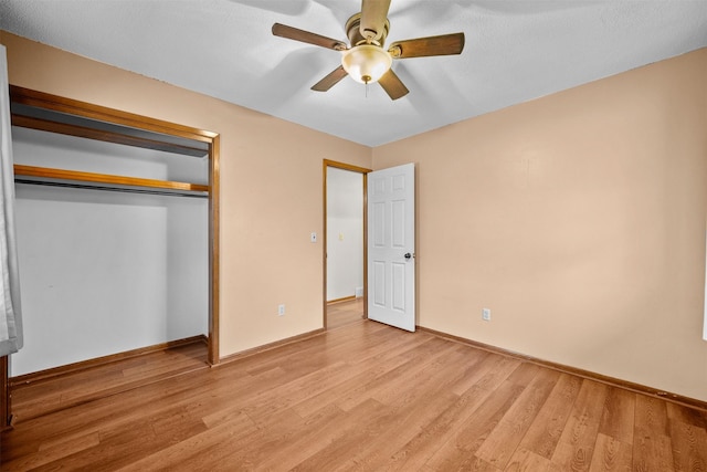 unfurnished bedroom featuring light hardwood / wood-style floors, ceiling fan, and a closet