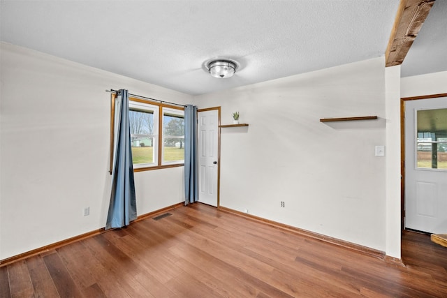 unfurnished room featuring hardwood / wood-style floors