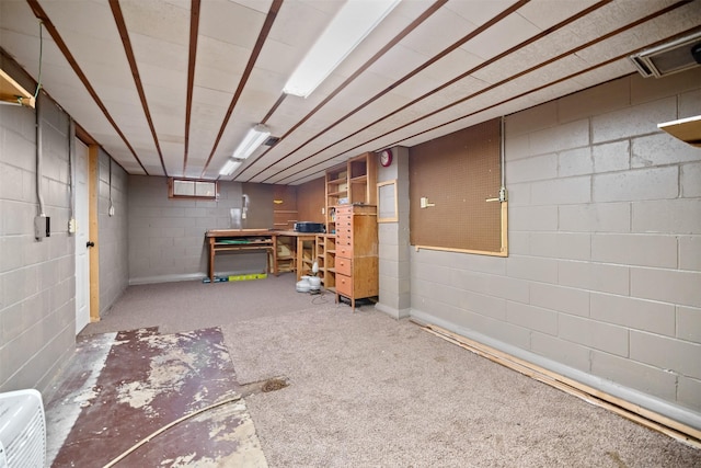 basement featuring carpet floors and a workshop area