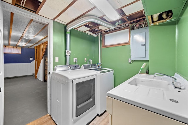 clothes washing area featuring separate washer and dryer, plenty of natural light, sink, and electric panel