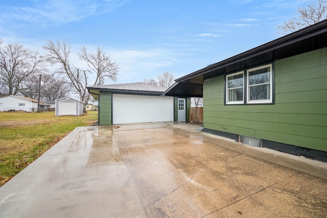 view of home's exterior featuring a garage, an outdoor structure, and a yard