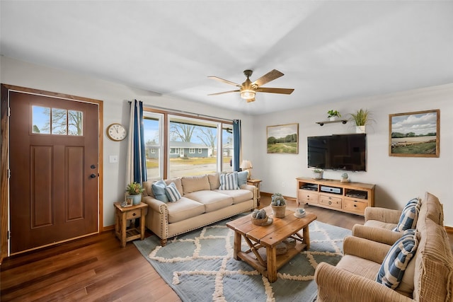 living room featuring dark wood-type flooring and ceiling fan