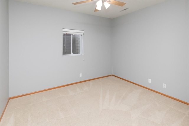 spare room featuring carpet flooring and ceiling fan