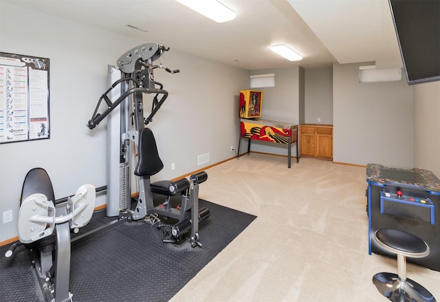 exercise room featuring light colored carpet