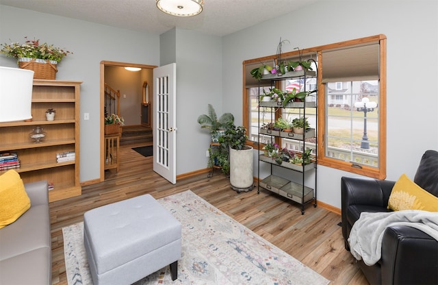 sitting room featuring hardwood / wood-style floors and a textured ceiling