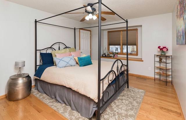 bedroom with wood-type flooring and a textured ceiling