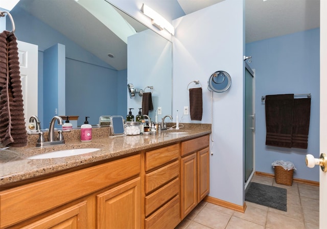 bathroom featuring vanity, tile patterned floors, and a shower with shower door