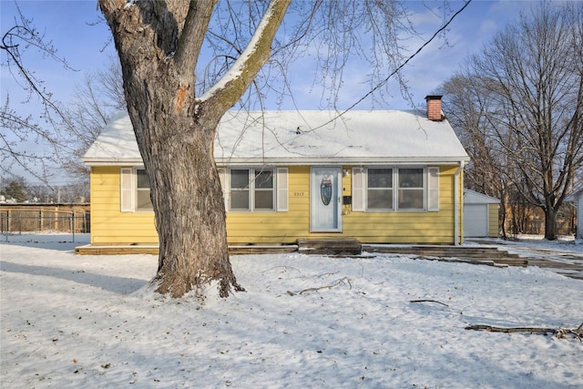 view of front of house featuring an outdoor structure and a garage