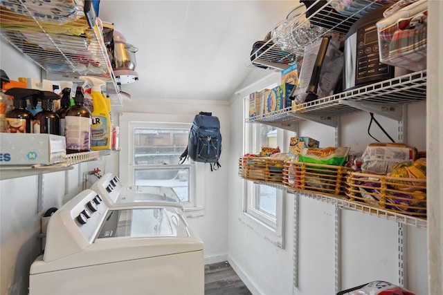 laundry area featuring plenty of natural light, washer and dryer, and hardwood / wood-style flooring