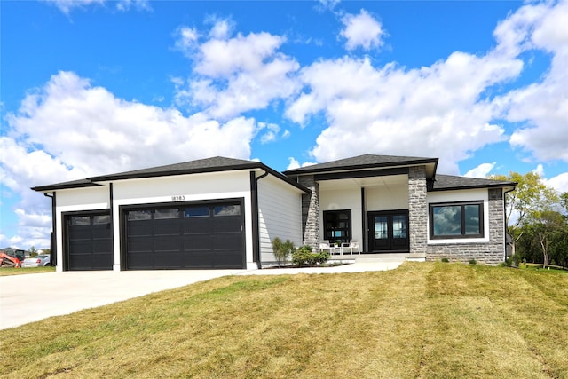 prairie-style home featuring a front yard and a garage