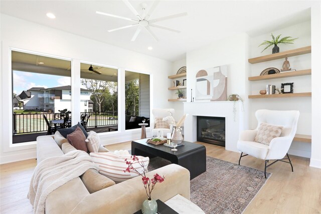 living room featuring ceiling fan and light wood-type flooring