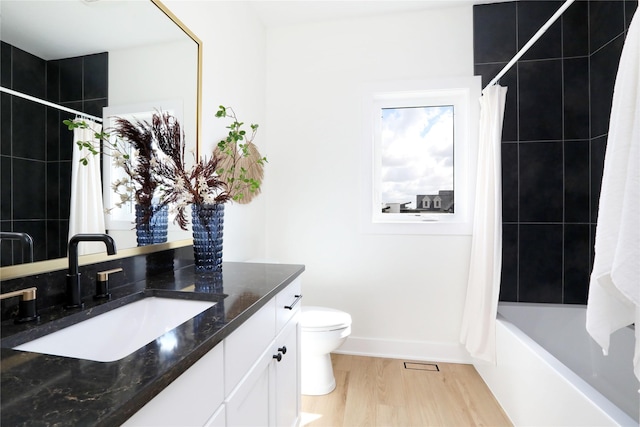 full bathroom with toilet, vanity, shower / tub combo, and hardwood / wood-style flooring