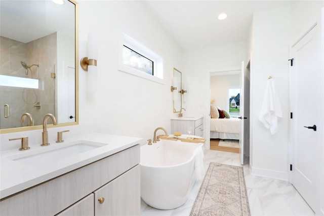 bathroom featuring shower with separate bathtub and vanity