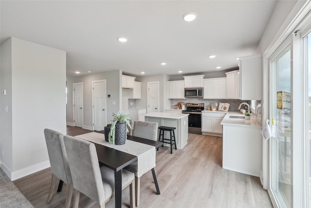 3251 NW Brookside Dr, Grimes, IA 50111 - dining area featuring recessed lighting, light wood-style flooring, and baseboards