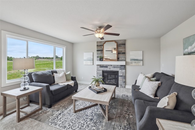 3251 NW Brookside Dr, Grimes, IA 50111 - living area featuring ceiling fan, baseboards, and a fireplace