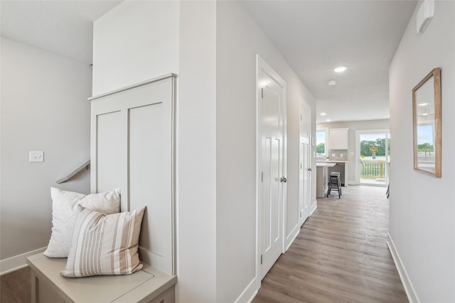 3251 NW Brookside Dr, Grimes, IA 50111 - hallway featuring recessed lighting, wood finished floors, and baseboards