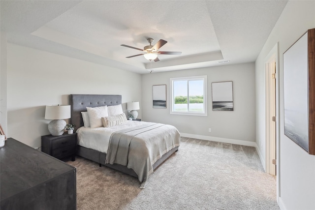 3251 NW Brookside Dr, Grimes, IA 50111 - bedroom with a raised ceiling, carpet, ceiling fan, baseboards, and a textured ceiling