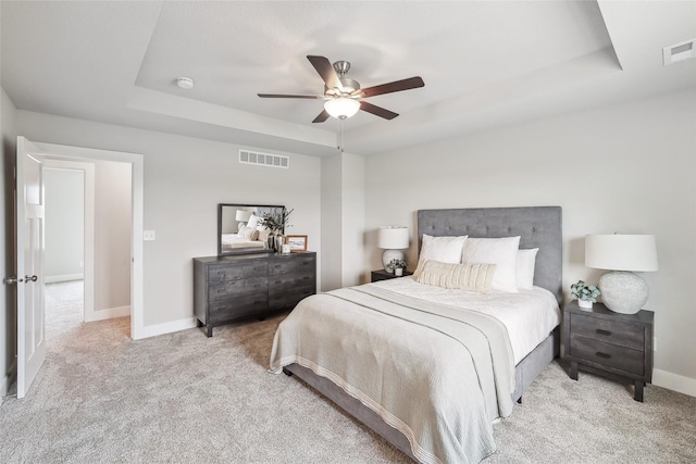 3251 NW Brookside Dr, Grimes, IA 50111 - bedroom with a tray ceiling, carpet flooring, baseboards, and ceiling fan