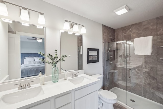 3251 NW Brookside Dr, Grimes, IA 50111 - ensuite bathroom featuring a stall shower, double vanity, toilet, and a ceiling fan