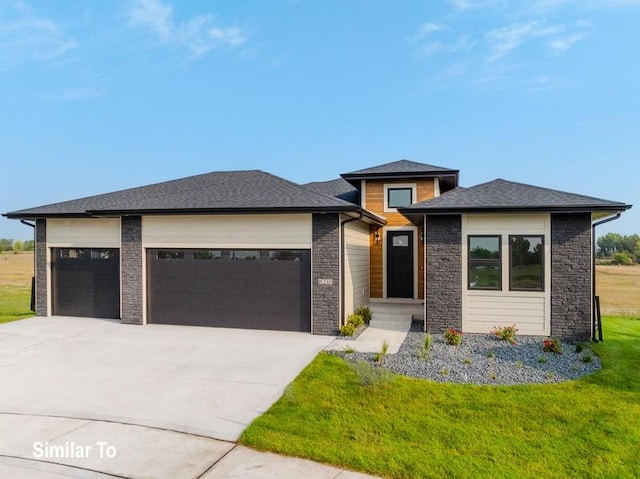 prairie-style house with a garage and a front lawn