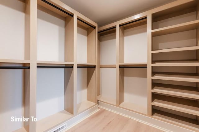 walk in closet featuring hardwood / wood-style floors