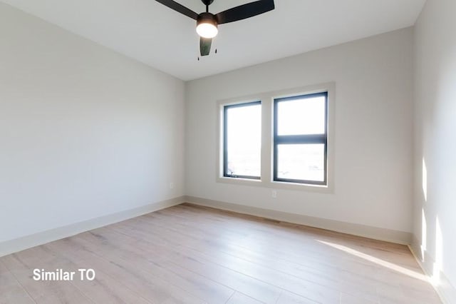 spare room featuring light wood-type flooring and ceiling fan