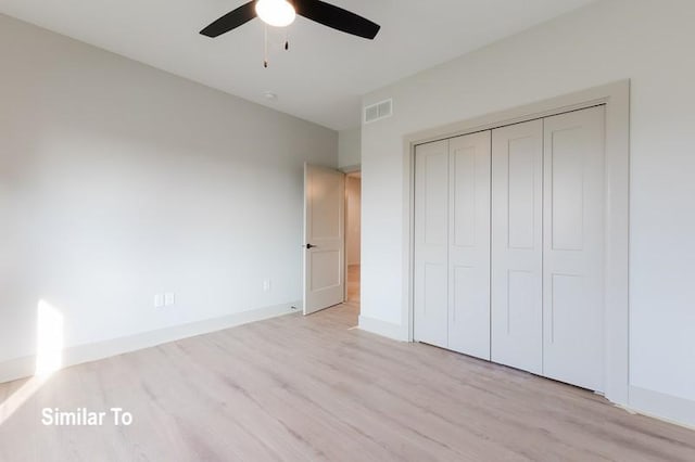 unfurnished bedroom featuring a closet, ceiling fan, and light wood-type flooring