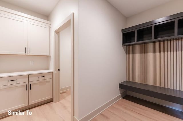 mudroom with light hardwood / wood-style flooring