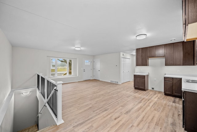 kitchen featuring dark brown cabinets and light hardwood / wood-style floors