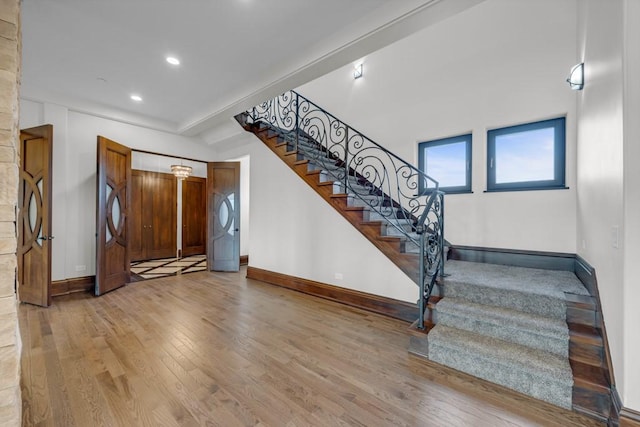 stairway with hardwood / wood-style floors