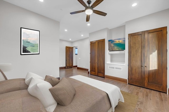 bedroom with light wood-type flooring and ceiling fan