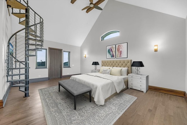 7217 NW 107th St, Johnston, IA 50131 - bedroom featuring high vaulted ceiling, baseboards, wood finished floors, and ceiling fan