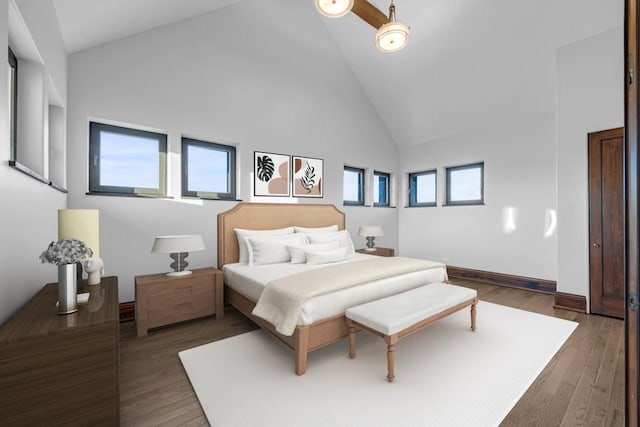 bedroom with dark hardwood / wood-style floors and high vaulted ceiling