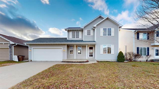 front of property with a garage and a front lawn