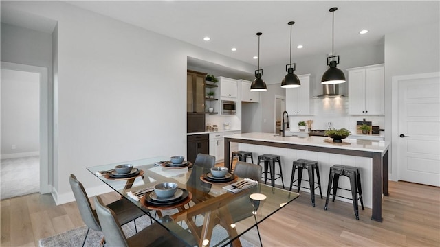 dining room with sink and light hardwood / wood-style floors