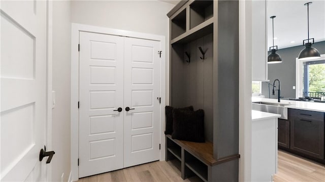 mudroom featuring light wood-type flooring and sink