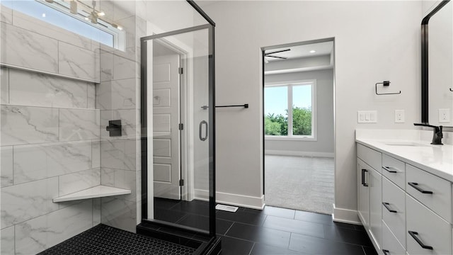 bathroom with tile patterned flooring, vanity, and walk in shower