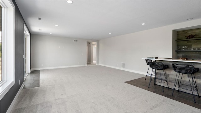 interior space with dark carpet and a wealth of natural light