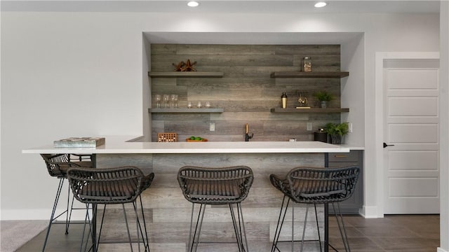 bar featuring wooden walls and dark tile patterned floors