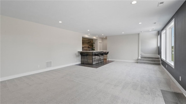 unfurnished living room with light colored carpet