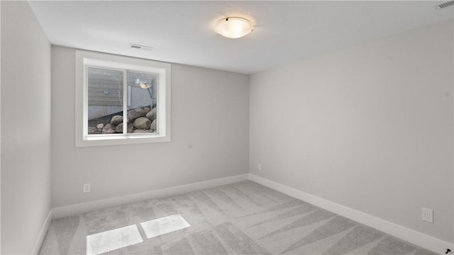 unfurnished room with light carpet