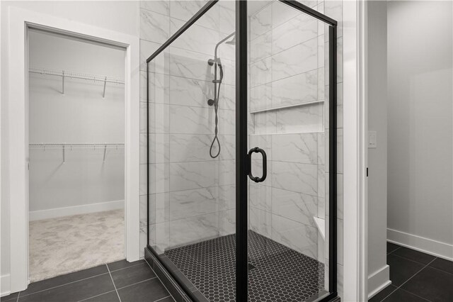 bathroom featuring tile patterned flooring and an enclosed shower